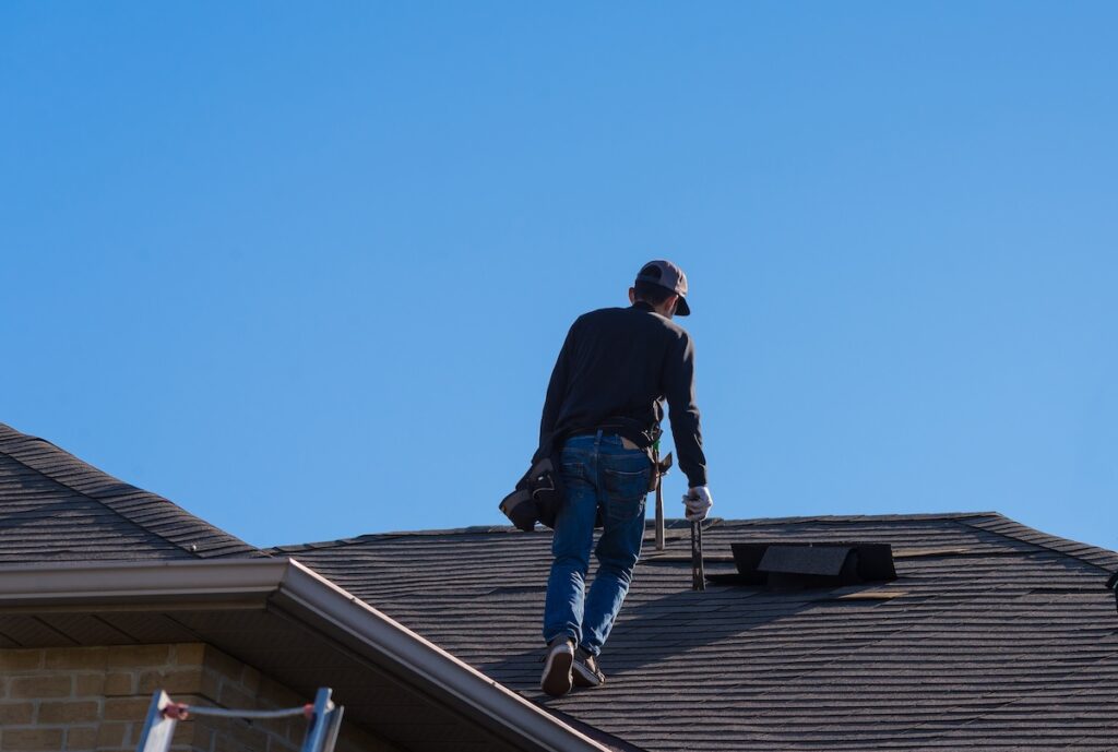 Worker walking on a damaged roof