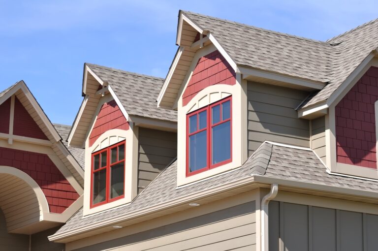 Architectural shingles on a house with red accent siding