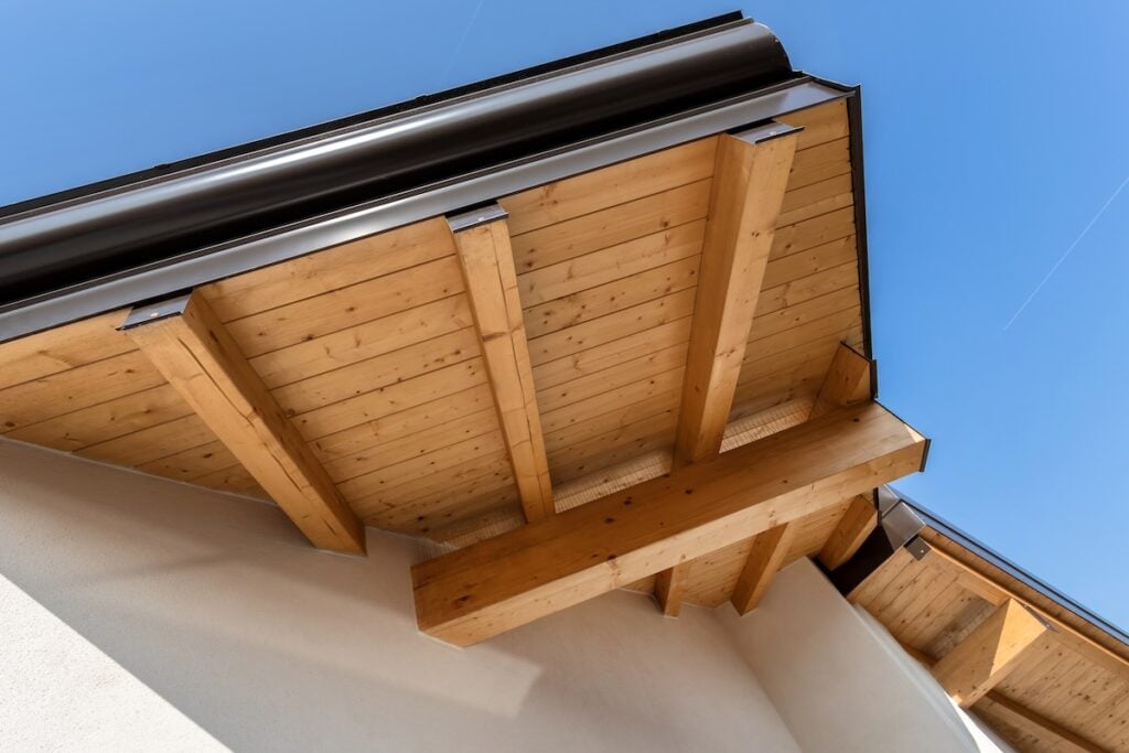 New wooden warm ecological house roof with steel gutter rain system