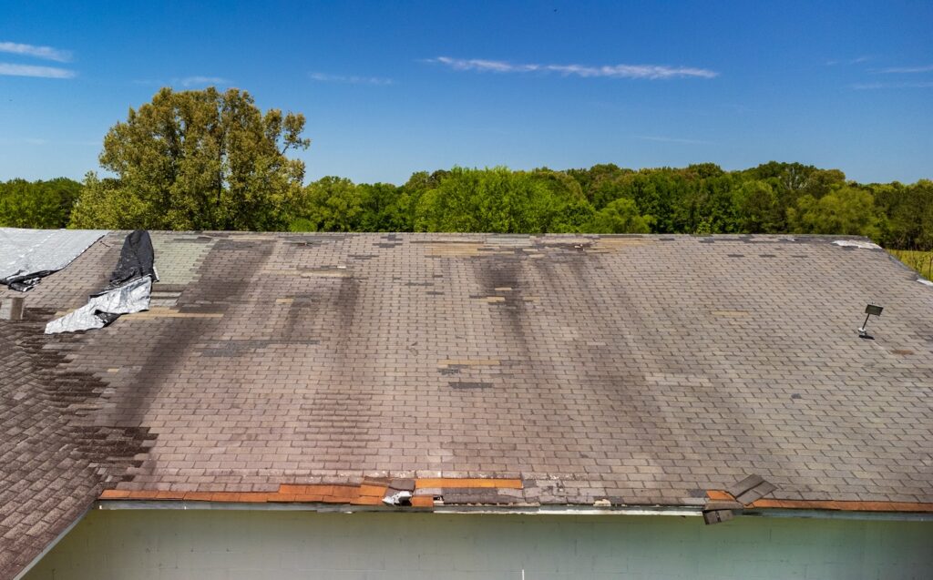 Roof missing shingles due to age, weather and storm damage