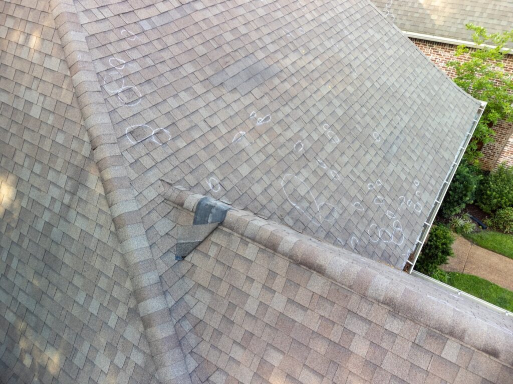Roof with hail damage and chalk markings from inspection