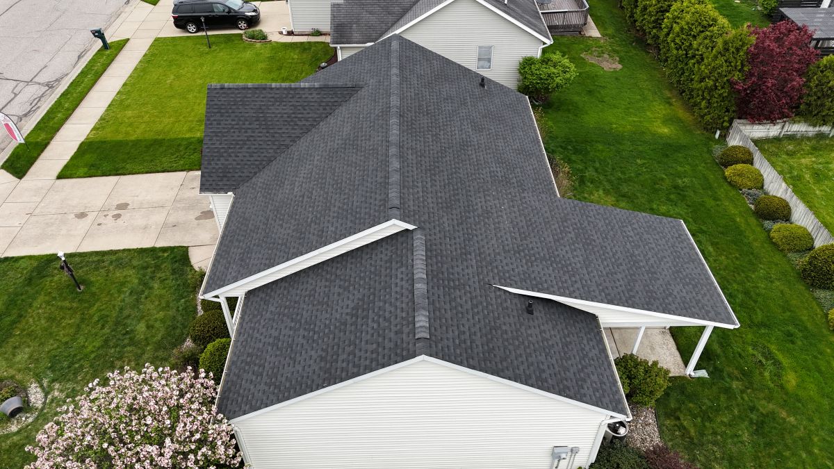 dark grey asphalt shingle roof on a white residential house