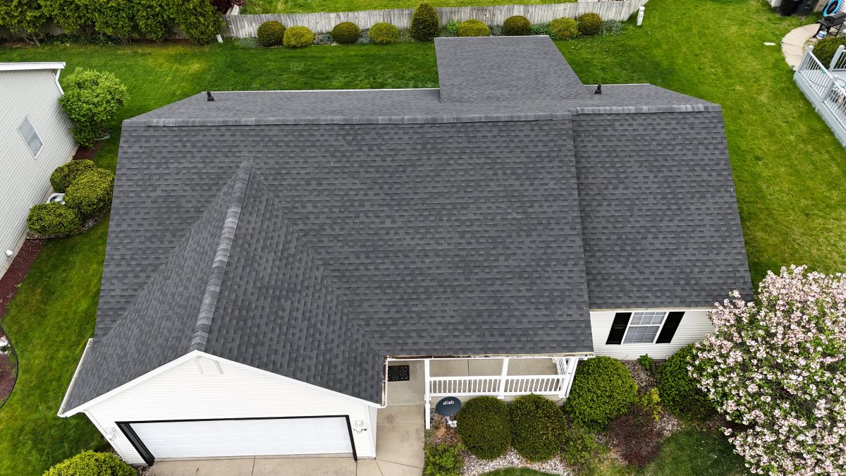 A house with a newly installed grey shingle roof