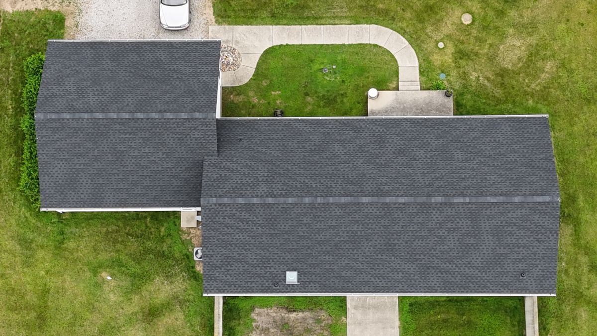 Aerial view of a house with dark grey shingles