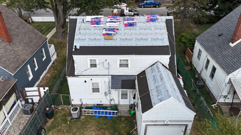 One Way Roofing installing a new roof on a white house