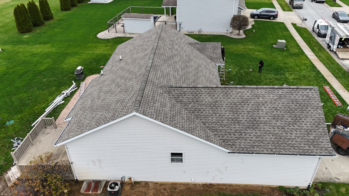 A white house with a grey shingle roof