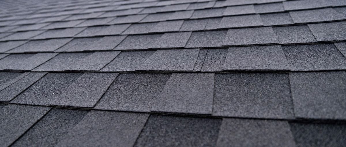 Selective focus texture of dark gray asphalt roof shingles