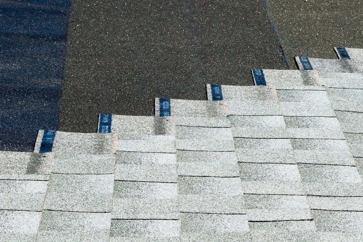 asphalt shingles being installed on top of roof underlayment