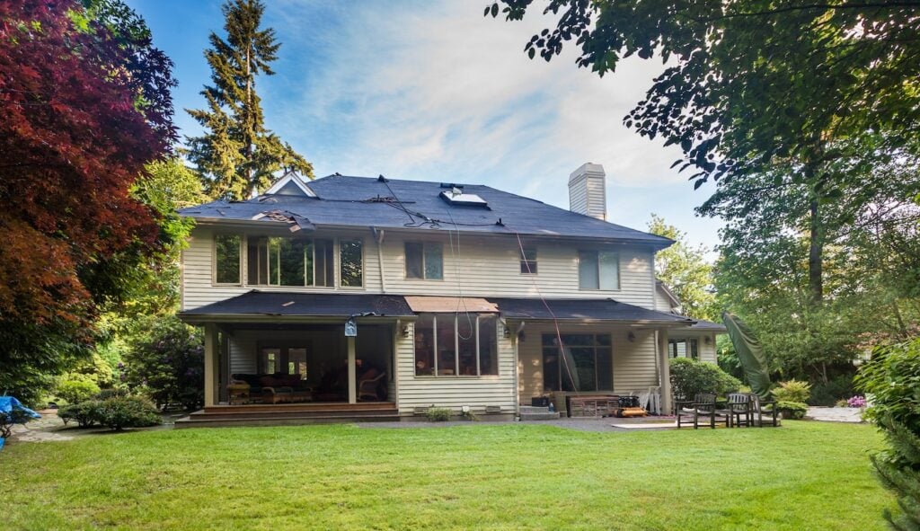 Old roof shingles removed from rear of home