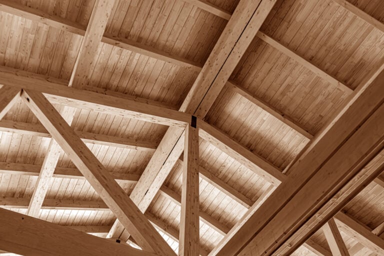 roof rafters vs trusses The construction of the wooden roof. Detailed photo of a wooden roof overlap construction.