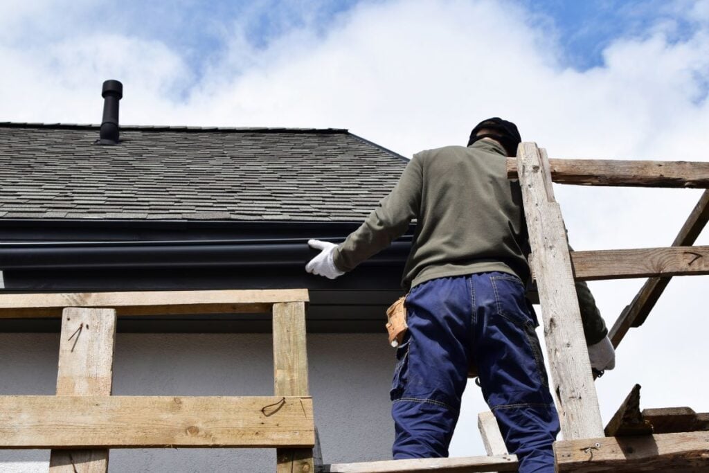 half round copper gutters guy installing new gutter