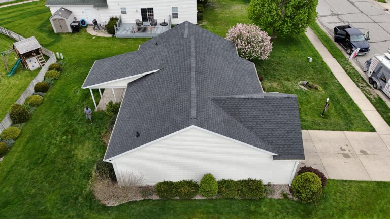 composition roof vs shingles aerial view of big house