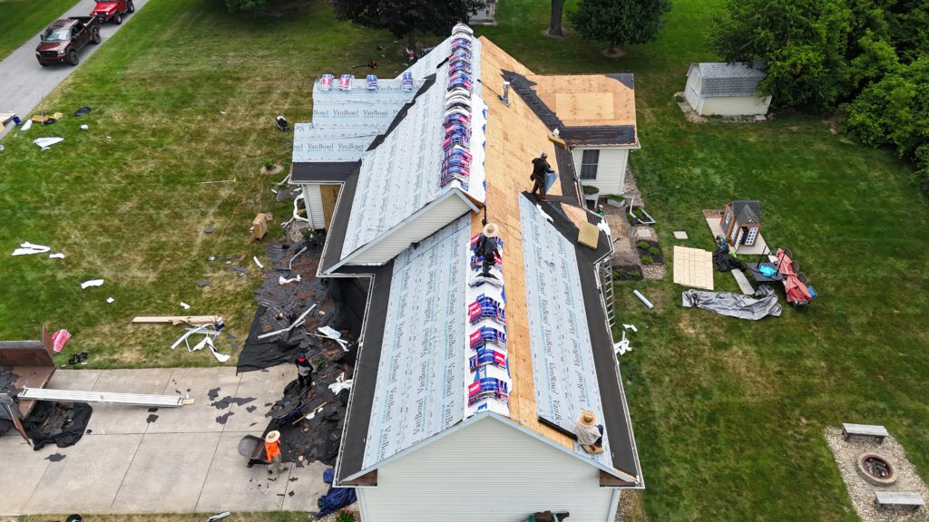 workers installing new shingles roof