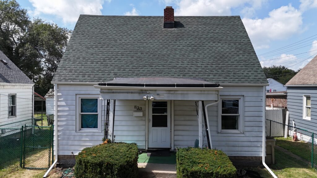 composition roof vs shingles front view of small house