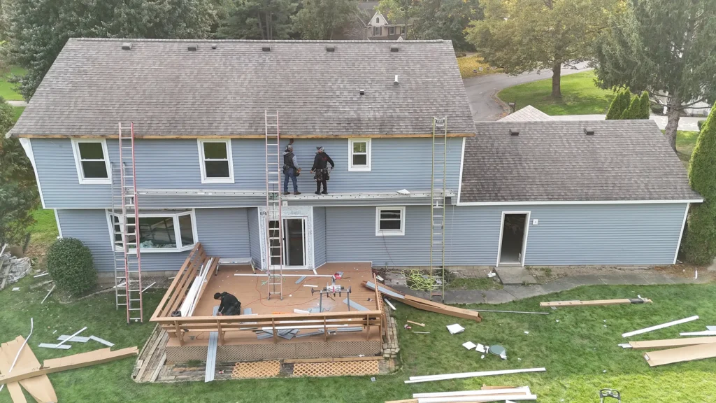 team repairing siding vinyl siding vs fiber cement