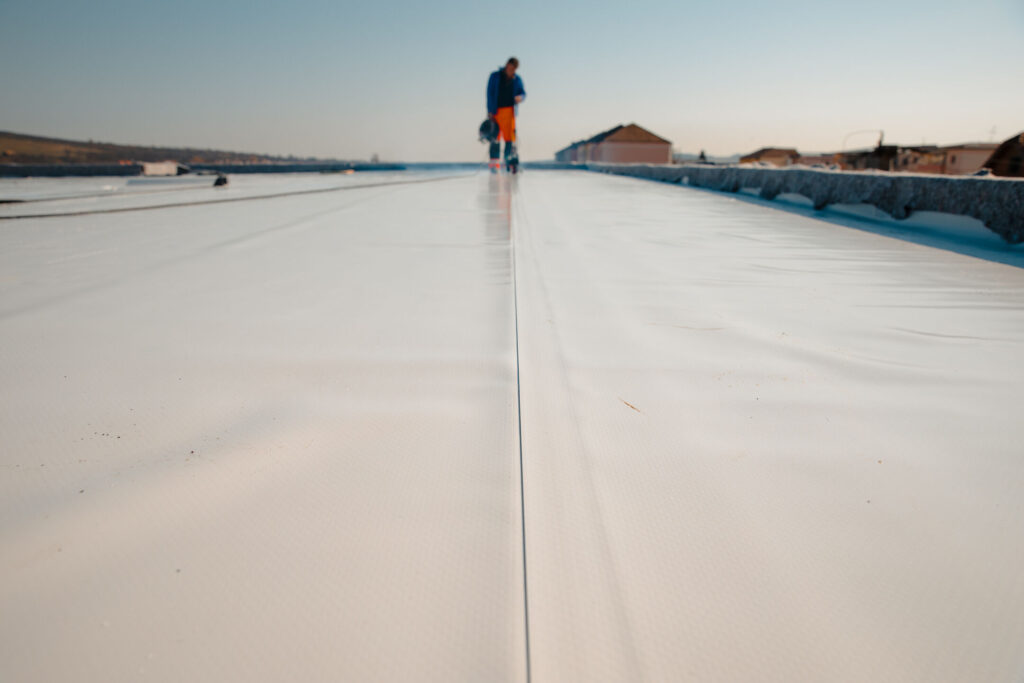 guy installing PVC roof