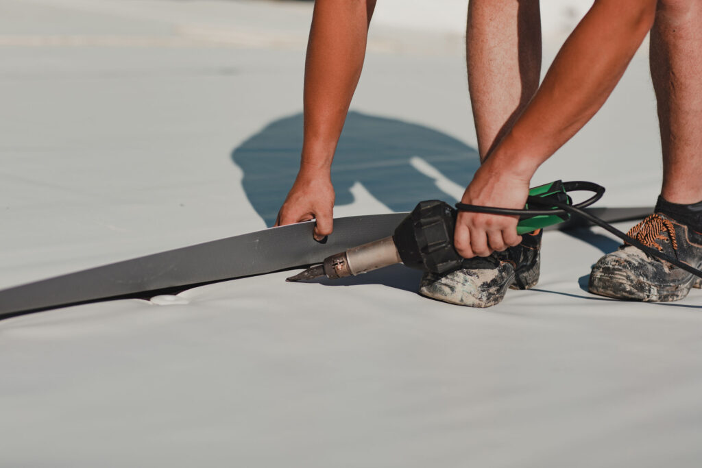 guy using heatgun on pvc membrane system