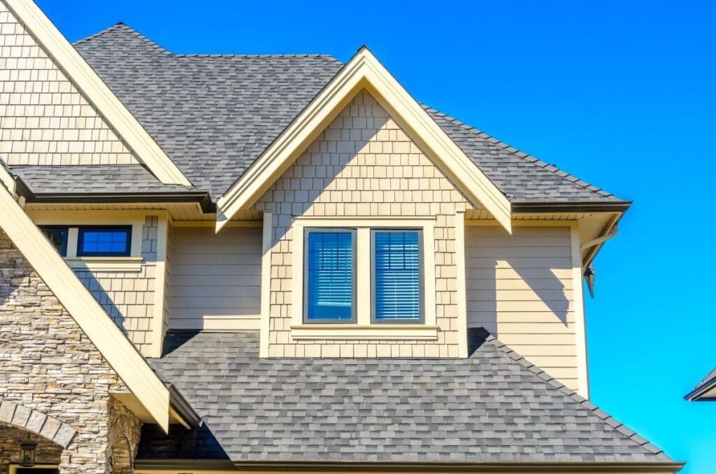 yellow siding grey shingles roof
